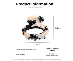 Detail view of oval marble acetate hair claw showing 3.6cm size and handmade logo
