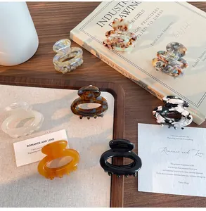Assorted vintage floral acetate hair claws in various marble and tortoiseshell patterns