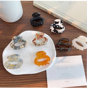 Detail of assorted floral acetate hair claws with premium resin finish and spring closure