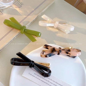 French style acetate bow hair clips in olive green, pearl white, tortoiseshell, and black