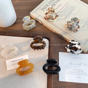 Set of 8 minimalist acetate hair claws in various floral, marble, and amber patterns