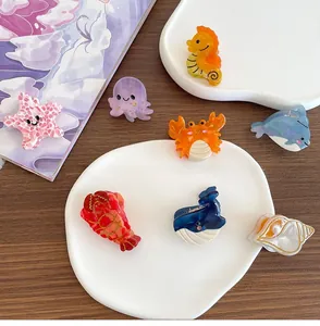 Detailed view of ocean theme hair claws featuring colorful acetate sea creatures set