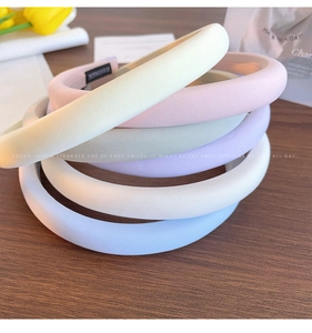 Close-up of pastel sponge padded headbands in cream pink green and blue colors