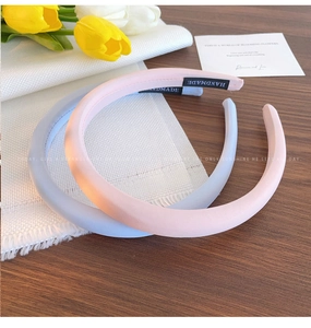 Detailed view of thick handmade sponge headbands in light pink and blue fabric