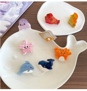 Detailed collection of cartoon sea creature hair claws in colorful acetate finishes
