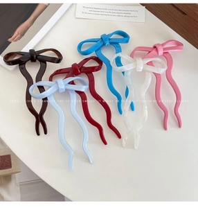 Detail of colorful bow hair pins in acetate finish for elegant women hairstyles