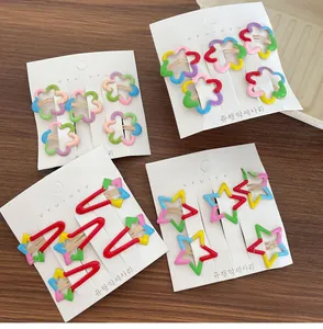 Colorful floral and star-shaped hair clips for girls set on white display card