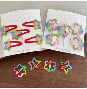 Detail of colorful star and flower hair clips in various shapes for children's styling