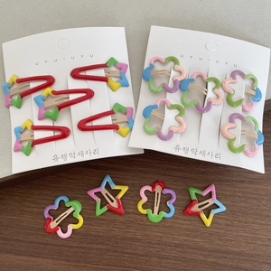 Cute rainbow star and flower hair clips set for kids on card with wood background