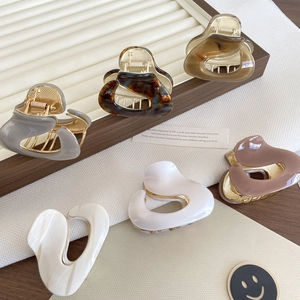 Elegant cream and tortoiseshell acetate hair claw clips in various minimalist shapes