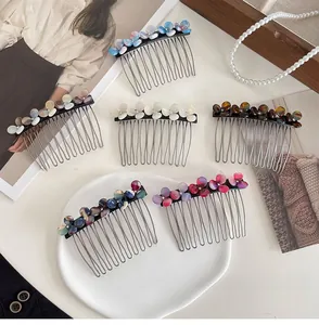Detailed close-up of six assorted acetate flower hair combs for bangs styling