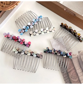 Detailed view of six floral acetate hair side combs with elegant rhinestone accents