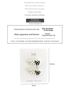 Polka dot hair clip set on display card with product specifications and 14g weight info