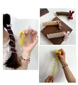 Detail showing colorful spiral hair ties with acetate bow accents for bubble braids