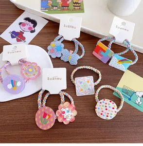 Detail of colorful macaron hair ties with cute resin charms like flowers and stars