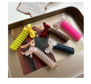 Detail of colorful acetate bow telephone wire hair ties in various elegant Morandi colors
