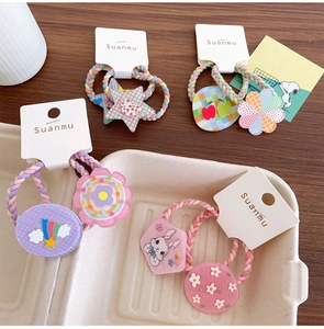 Detailed view of colorful elastic hair bands with acrylic stars and floral charms