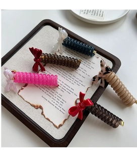 Detailed view of acetic acid bow hair ties with phone cord spirals in five colors