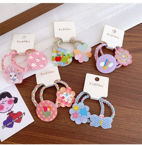 Detail of colorful braided elastic hair ties with cute acrylic rabbit and flower charms