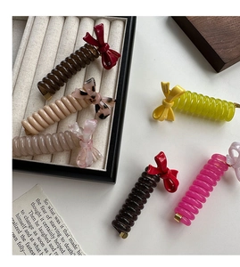 Close-up of colorful spiral hair ties with bows featuring France Handmade lettering