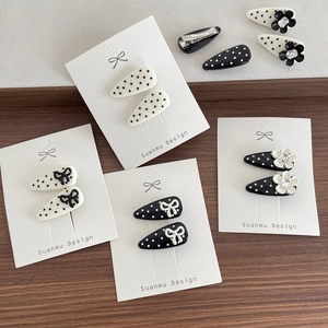 Polka dot hair clip set with 3D bows and small flowers on elegant display card