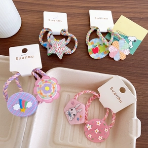Colorful kids elastic hair ties set with cute cartoon star and flower charms on wooden background