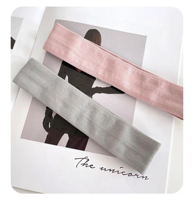 Detail of pink and grey ribbed elastic headbands showing soft knit fabric texture for sports