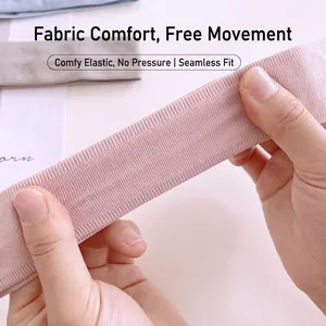 Elastic pink ribbed sports headband being stretched to show high breathability and flexibility