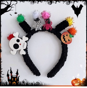 Detail of Halloween headband featuring plush texture with colorful pom-poms and spooky motifs