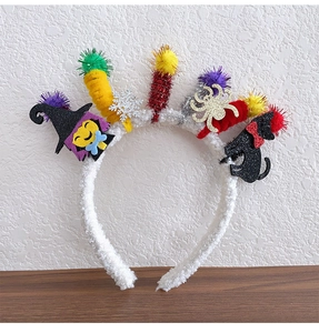 Detail of Halloween headband featuring witch, black cat and golden spider decorations