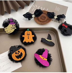 Close-up of Halloween hair clips set with pumpkin, ghost and witch hat designs