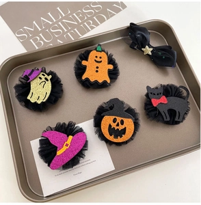 Detail of Halloween hair clips set featuring glitter pumpkin, ghost, and witch hat motifs