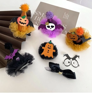 Flat lay of Halloween hair clips featuring glitter pumpkins, bats and mesh wizard hats