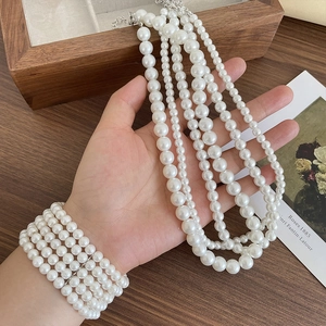 Elegant multi-layer white pearl necklace and bracelet set for women with silver clasp