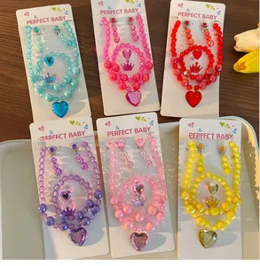 Detailed view of children's colorful bead jewelry sets with heart pendants and crowns