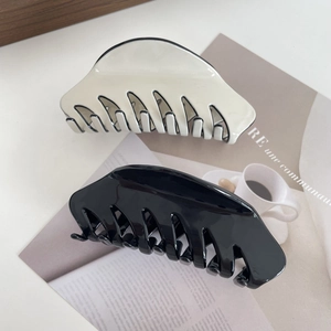 Classic French acetate shark hair claw clips in creamy white and glossy black