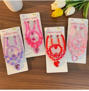 Detail of girls princess jewelry set with beaded heart necklaces and matching bracelets
