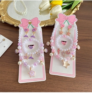Close-up of kids ocean jewelry sets with starfish and shell pendants on display cards