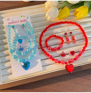Detail view of handmade heart-shaped gemstone jewelry sets for girls in red and blue