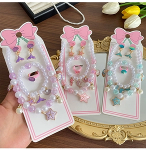 Detailed view of children's ocean jewelry set with pearls and starfish charms