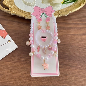 Detailed kids jewelry set with pink pearls, ocean charms like starfish on a display card