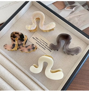 Detailed set of four tortoiseshell and pearl acetate hair claws in elegant wavy S-shape design