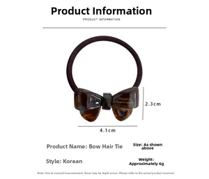 Detailed view of handmade acetate bow hair tie with tortoiseshell texture and elastic band
