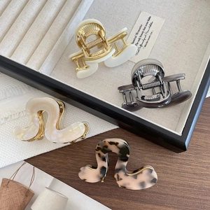 Set of four minimalist acetate hair claws in various elegant colors and wave designs
