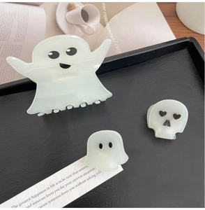 Close-up of Halloween ghost and skull hair clips set in white acetate material