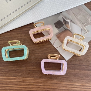 Square acetate hair claw clips in pastel marble colors with gold metal spring hinge