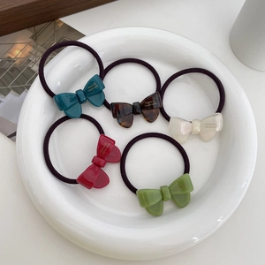 Five-piece acetate bow hair tie set in deep blue, brown, white, red, and green colors