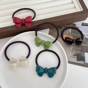 Set of five elegant acetate bow hair ties in assorted colors with handmade gold lettering