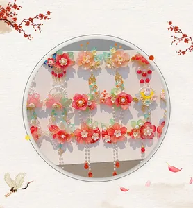 Detailed view of traditional Chinese flower hair clips with long pearl tassels for girls