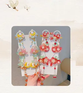 Detail of traditional Chinese hair clips with flowers, moon rabbits and long tassels